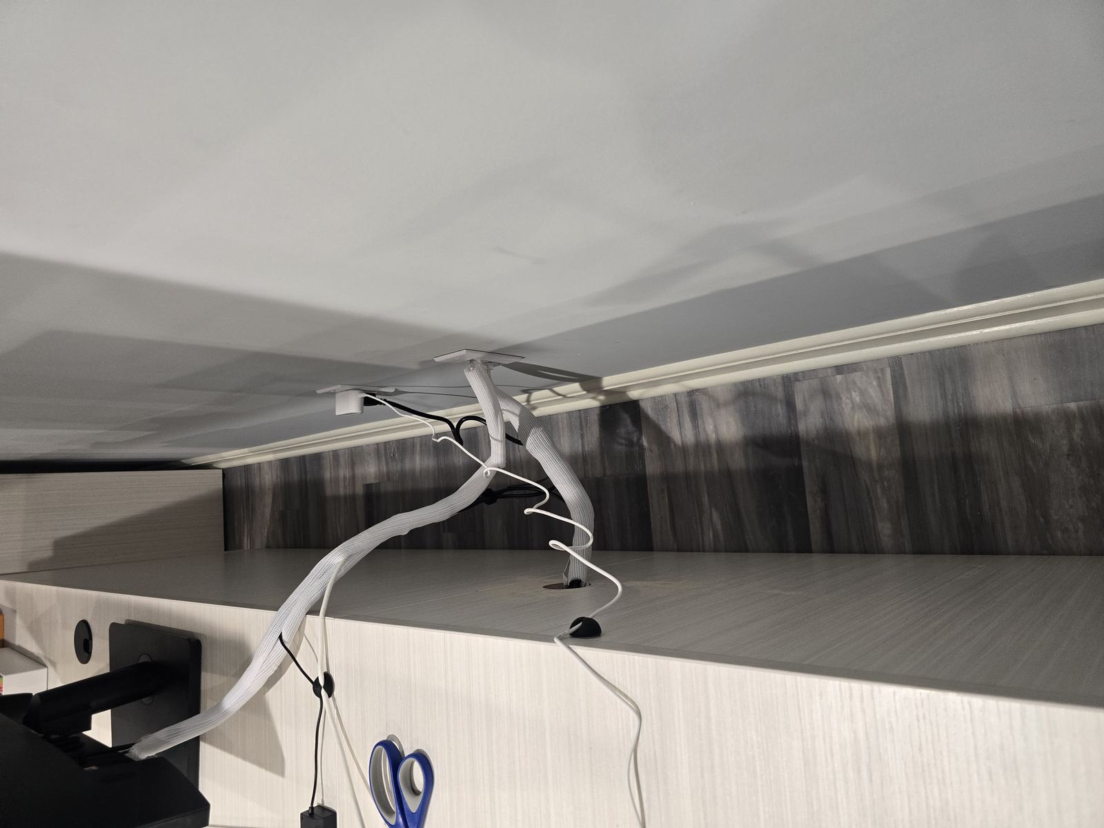 Cable loom routed from desk to wall