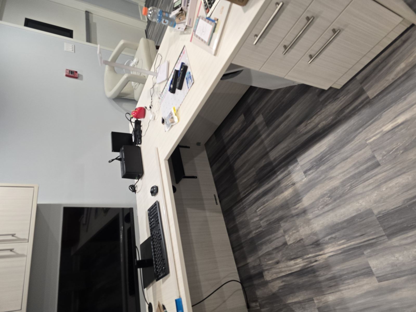 Finished L-shaped office desk with monitor and cabinetry